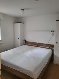 a bedroom with a large white bed in it at Beachbungalow in Karlshagen