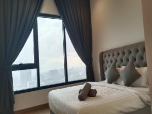 a bedroom with a bed with a large window at Luxury Suite Lucentia BBCC Infinity Pool in Kuala Lumpur +34 photos
