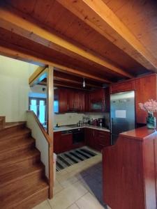 a kitchen with wooden cabinets and a staircase in a kitchen at Seaview Maisonette Paradise in Pláka