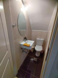 a small bathroom with a sink and a toilet at Seaview Maisonette Paradise in Pláka +13 photos