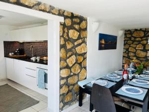 a dining room with a table and a kitchen at Villa Julia in Velence