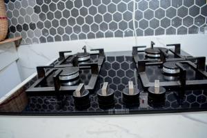 a black stove top in a kitchen with at Tropical lodge in Kakamega +26 photos