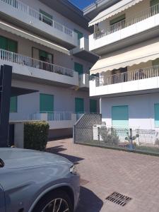 a car parked in front of a building at Residence Mara in Lido di Jesolo