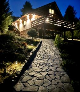 a stone path in front of a house at night at Chata pod Grúňom in Veľké Borové