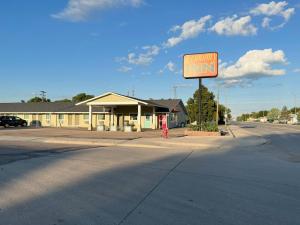 a sign in front of a small inn on a street at Economy Inn McCook in McCook