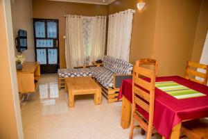 a living room with a couch and a table at Maili 6 Private Apartments in Moshi