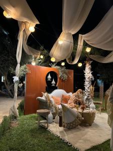 a patio with a table and chairs under a tent at Villa de luxe in Marrakech