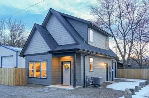a small house with a black roof at New modern home - movie and game room - Family Friendly in Post Falls