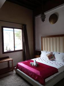 Postel nebo postele na pokoji v ubytování Auberge kasbah tifirte + 12 fotografií