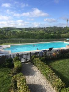 a swimming pool with people swimming in it at La Sautie in Bars