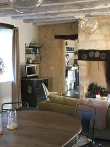 a living room with a couch and a table at La Sautie in Bars