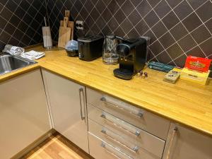 a kitchen counter with a blender on top of it at Two-Bedroom City Apartment with Fire Place, Free Parking and Fjordview Terrace - Calm and Central in Ålesund +24 photos