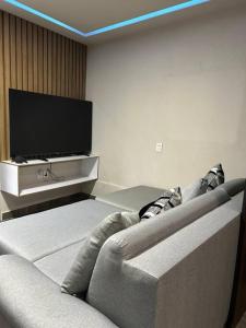 a living room with a couch and a flat screen tv at Loft oros in Oaxaca City