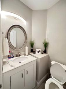 a bathroom with a sink and a toilet and a mirror at California Dreams in Lancaster +25 photos