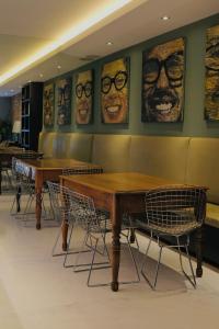 a dining room with two tables and glasses on the wall at Casa Mannach in Mexico City