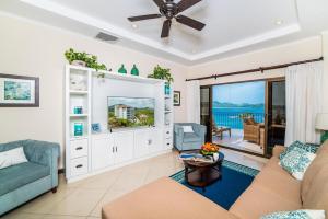 a living room with a couch and a table at Oceanfront Infinity Pool and Sunset Veranda in Playa Flamingo