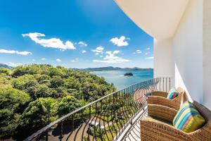 a balcony with a view of the ocean at Oceanfront Infinity Pool and Sunset Veranda in Playa Flamingo