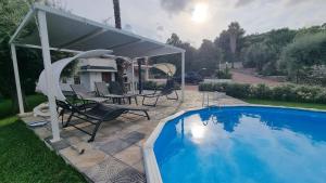 a swimming pool with a pavilion next to a house at Villa Hippodrom-INDEPENDENT VILLA WITH POOL in Syracuse