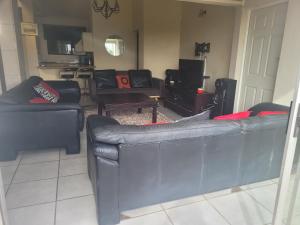 Una sala de estar con dos sofás y un televisor. en 44 on Lyme Road, en St Francis Bay