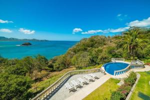 an aerial view of a swimming pool and the ocean at Oceanviews, Private Veranda, 2 Pools & Concierge in Playa Flamingo