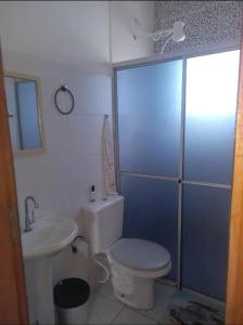 a bathroom with a white toilet and a sink at casa itanhaém in Itanhaém