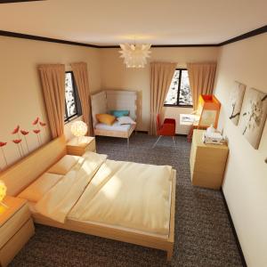 a bedroom with a large bed and a living room at Chalet Hakuba in Hakuba