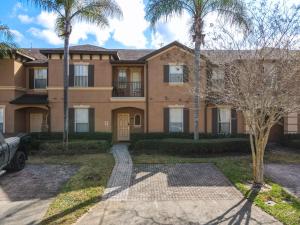 a house with palm trees in front of it at Charming & Cozy Getaway! Lazy River! in Davenport