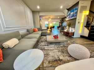 a living room with a couch and a table at Lux Townhome Free Parking 12 min to BWI in Brooklyn Park