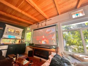 a person is playing a video game on a large screen tv at Sojourn Rustic Spa Retreat in Point Roberts