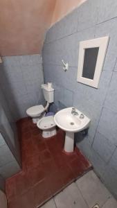 a bathroom with two toilets and a sink at Departamento- ZONA CENTRO in San Fernando del Valle de Catamarca