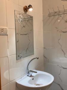 a bathroom with a sink and a mirror and a shower at MRHostel Luxor in Luxor +36 photos