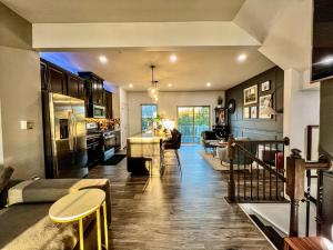 a room with a kitchen and a living room at Lux Townhome Free Parking 12 min to BWI in Brooklyn Park