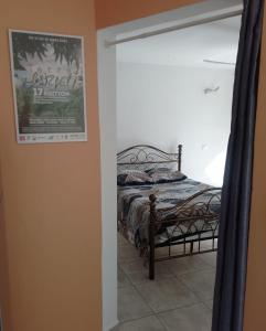 a bedroom with a bed with a poster on the wall at Le Triton in Deshaies +15 photos