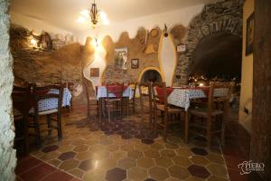 a restaurant with a table and chairs in a room at A Taverna Intru U Vicu in Belmonte Calabro