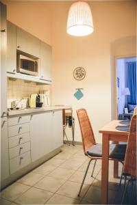 a kitchen and dining room with a table and chairs at Augarten Residences in Vienna