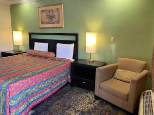 a hotel room with a bed and a chair at Cloud 9 in Cypress