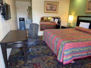 a hotel room with two beds and a desk at Cloud 9 in Cypress