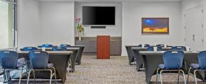 a conference room with tables and chairs and a flat screen tv at Las Vegas Desert Blue by HelloVacay in Las Vegas +64 photos