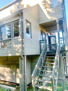 a house with stairs leading up to the front of it at Le Refuge des Cimes by Gestion ELITE in Mont-Tremblant