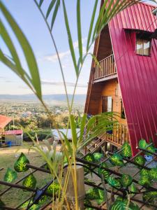 a tree house with a red roof at Casa Alpina - Barlovento Ecolodge Tarapoto - Matrimonial in Tarapoto