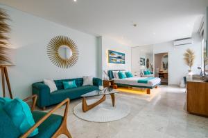 a living room with blue couches and a mirror at AQ-VA Hotel & Villas Seminyak in Legian +99 photos