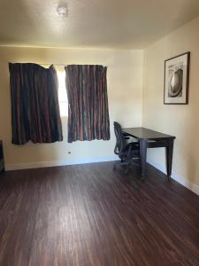 an empty room with a desk and a window at Cloud 9 in Cypress