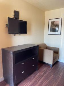 a living room with a couch and a flat screen tv at Cloud 9 in Cypress +9 photos