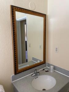 a bathroom with a sink and a mirror at Cloud 9 in Cypress