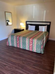 a bedroom with a large bed with a colorful bedspread at Cloud 9 in Cypress