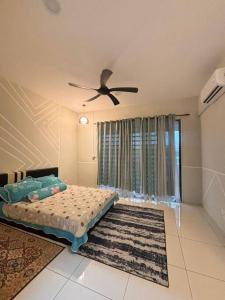 a bedroom with a bed and a ceiling fan at Hz homestay in Simpang Ampat