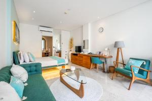 a living room with a couch and a bed at AQ-VA Hotel & Villas Seminyak in Legian