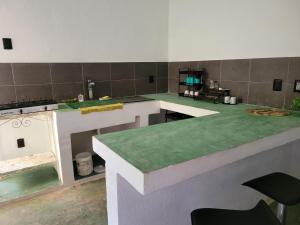 a kitchen with green counter tops in a room at Departamento Miguel Angel in Oaxaca City