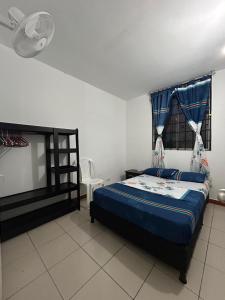 a bedroom with a bed and a chair in it at Apartamento en Villavicencio in Villavicencio