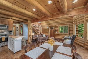 a dining room and kitchen in a log cabin at Bearfoot Chalet by NW Comfy Cabins in Leavenworth +57 photos